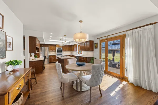 a dining room with furniture window and wooden floor