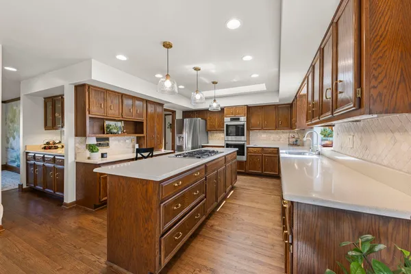 a kitchen with stainless steel appliances granite countertop a stove and a refrigerator