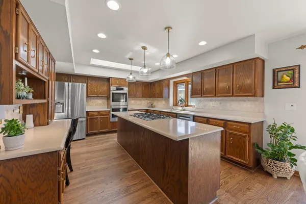 a large kitchen with granite countertop lots of counter space a sink and appliances