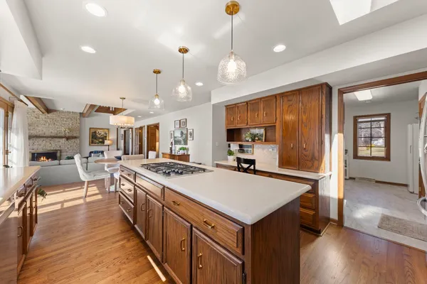 a large kitchen with stainless steel appliances a stove center island a cabinets and wooden floor