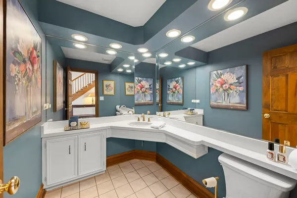 a bathroom with a sink a large mirror and a