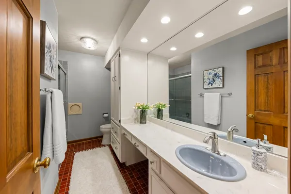 a bathroom with double vanity and a mirror