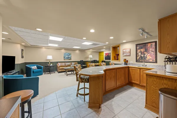 a kitchen with cabinets and chairs