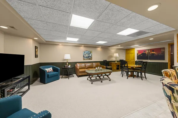 a lobby with furniture and a flat screen tv