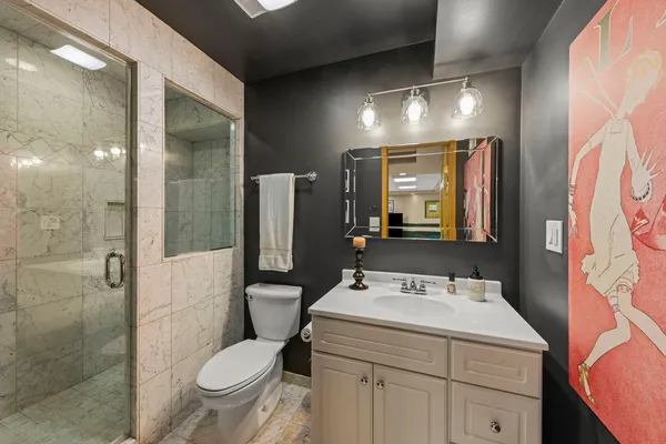 a bathroom with a sink toilet and shower