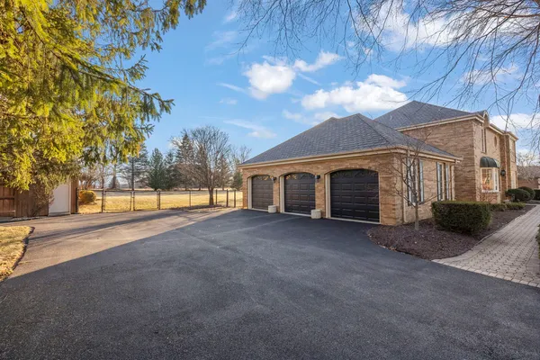 a view of a house with backyard and a tree