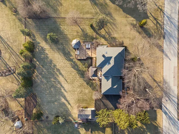 a aerial view of a house with a yard and wooden fence