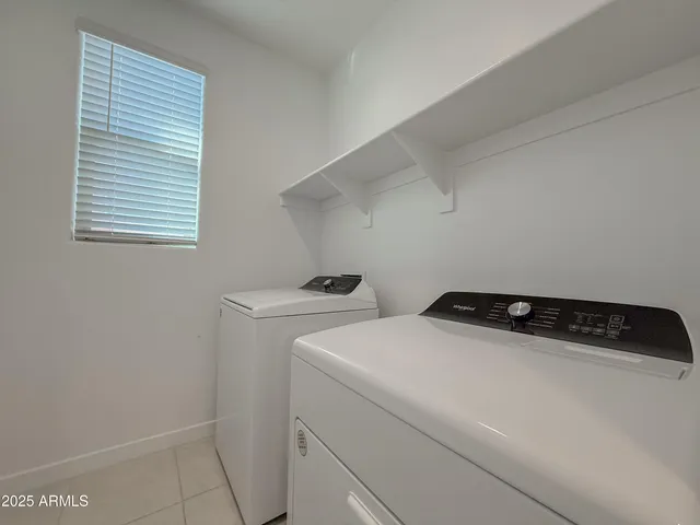 a view of kitchen with furniture and a refrigerator