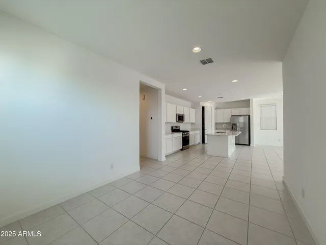 a view of a kitchen with white cabinets
