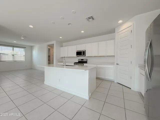 a view of kitchen with white cabinets
