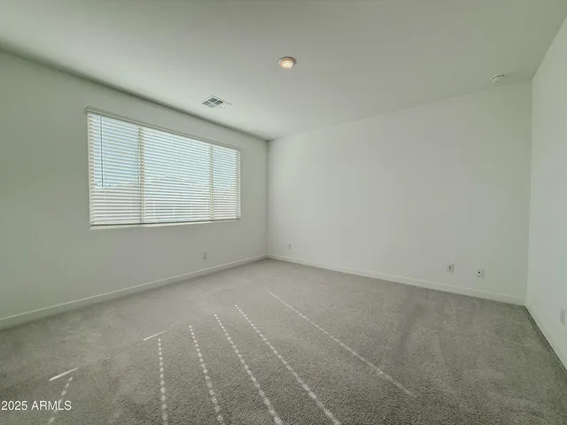 an empty room with a bathroom and a sink