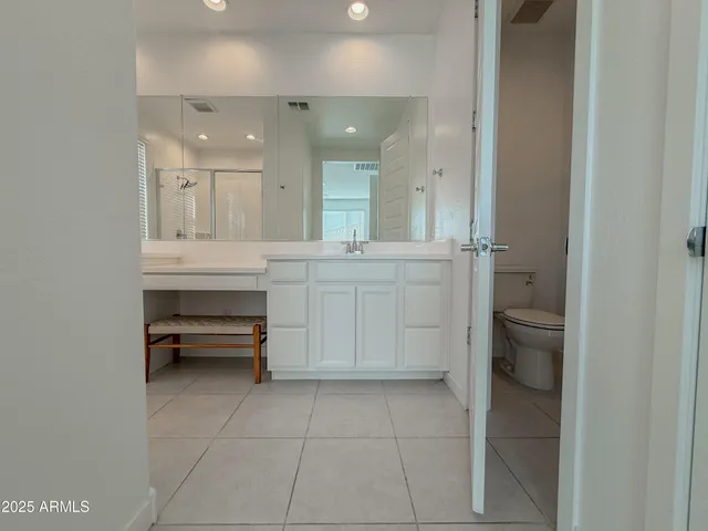 a bathroom with a sink a vanity and a mirror
