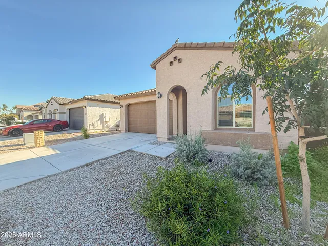 a front view of a house with garden