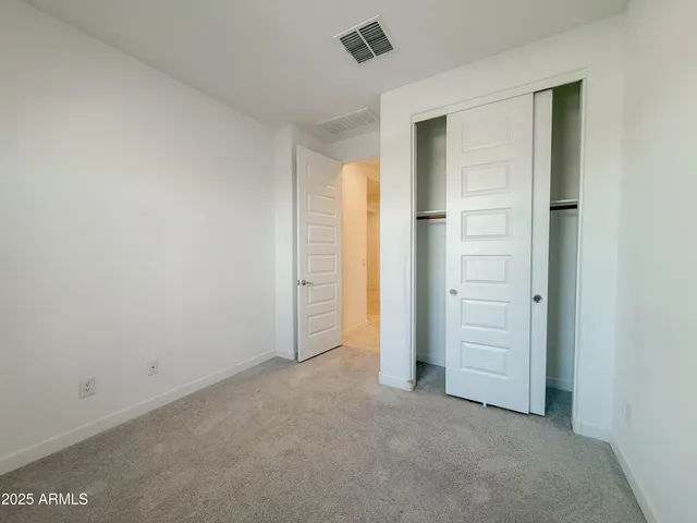 an empty room with closet area