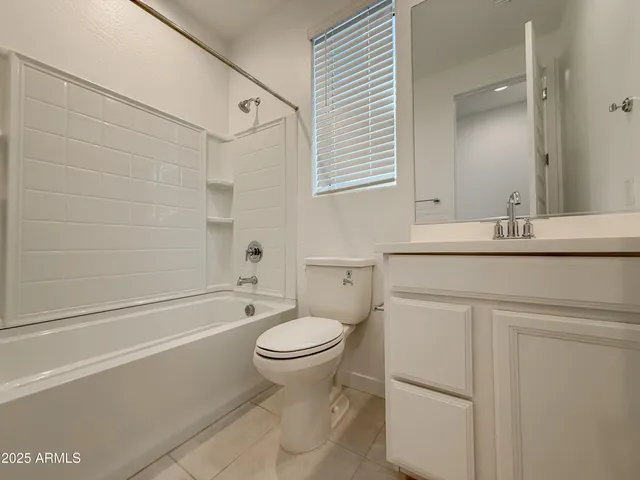 a bathroom with a sink toilet vanity and shower
