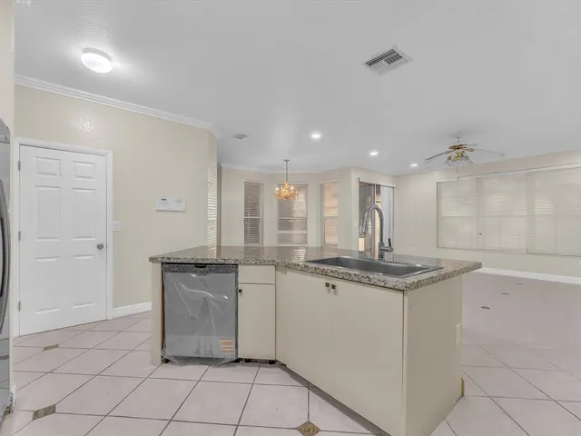 a kitchen with a sink a stove and cabinets
