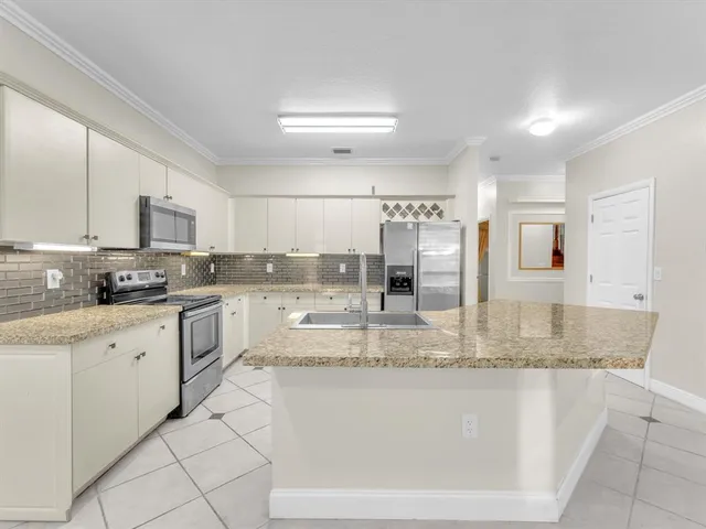 a view of a room with a chandelier fan and windows