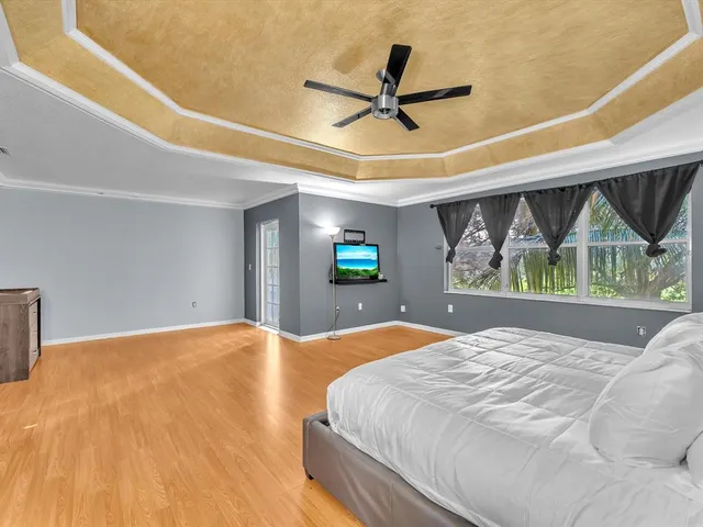 a bedroom with a bed and a ceiling fan