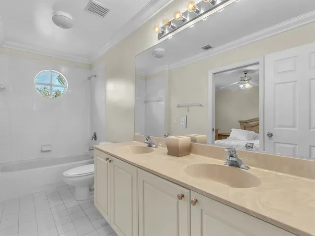 a view of an empty room with a chandelier fan