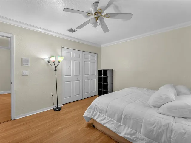 a view of empty room with a ceiling fan and wooden floor