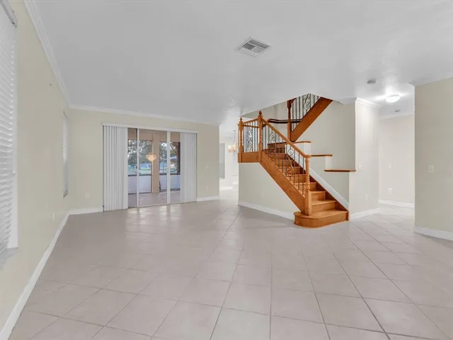 an empty room with closet and windows