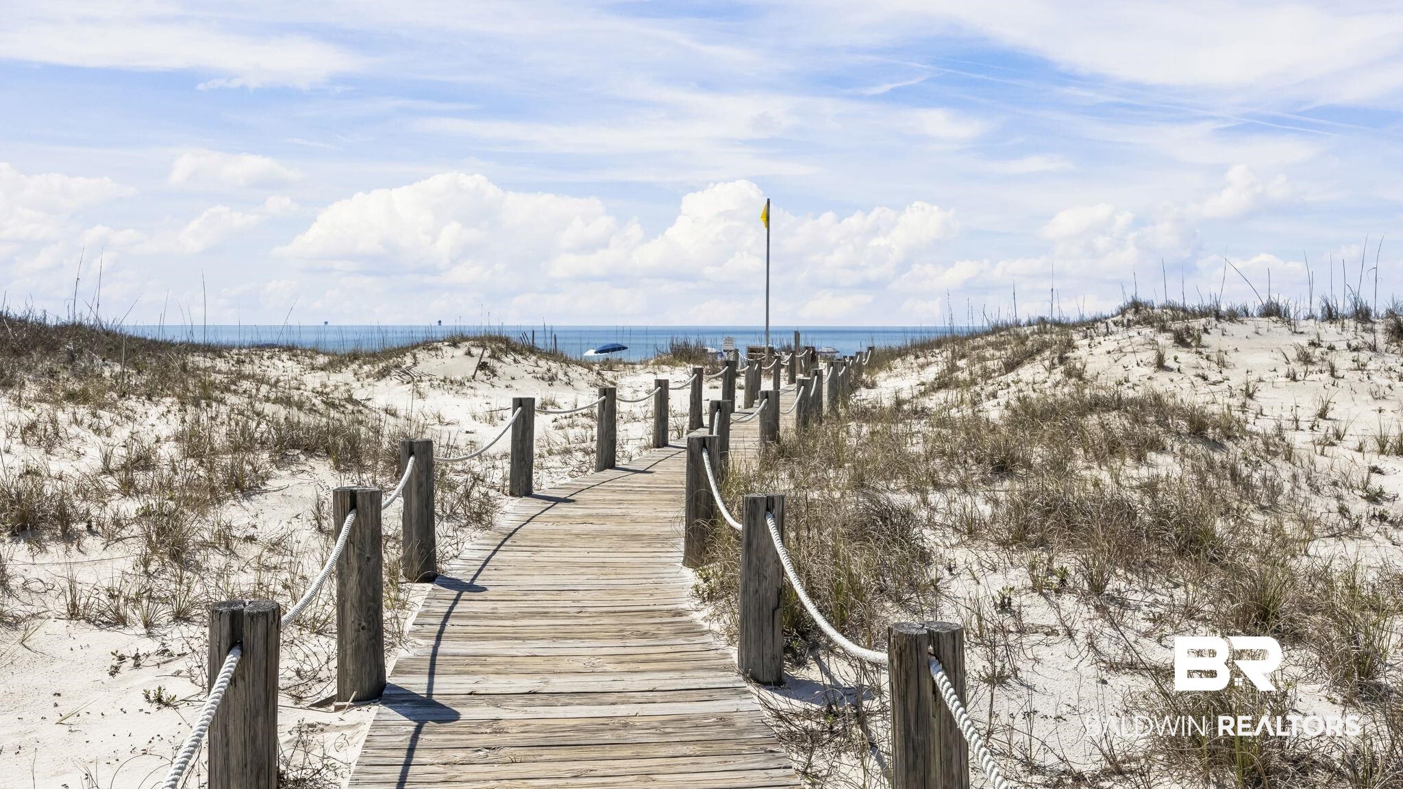 497 Plantation Road, Unit 1247 Gulf Shores, AL 36542 - Photo 23 of 29 Dock with view of water and beach