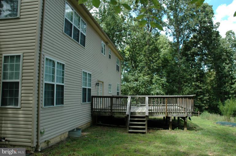 6931 North Stuart Road King George, VA 22485 - Photo 14 of 30 a front view of a house with a garden