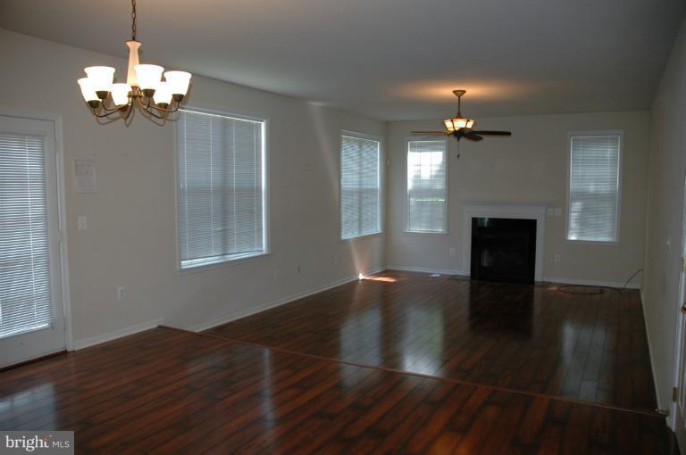 6931 North Stuart Road King George, VA 22485 - Photo 23 of 30 a view of a livingroom with a furniture wooden floor and chandelier