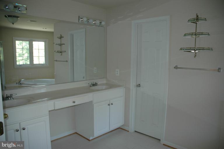 6931 North Stuart Road King George, VA 22485 - Photo 8 of 30 a bathroom with a shower sink and mirror