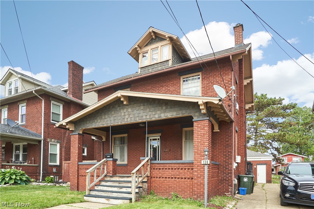 136 Smith Avenue Northwest Canton, OH 44708 - Photo 19 of 19 Brick exterior featuring a covered front porch with brick pillars, a dormer window, and a gabled roofline