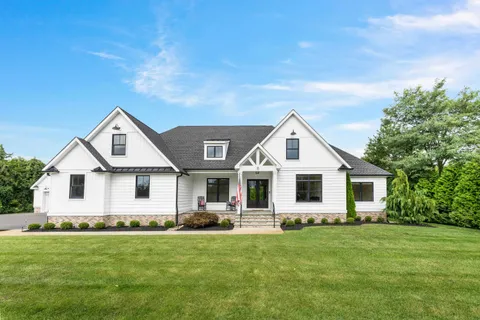 a front view of house with yard and green space
