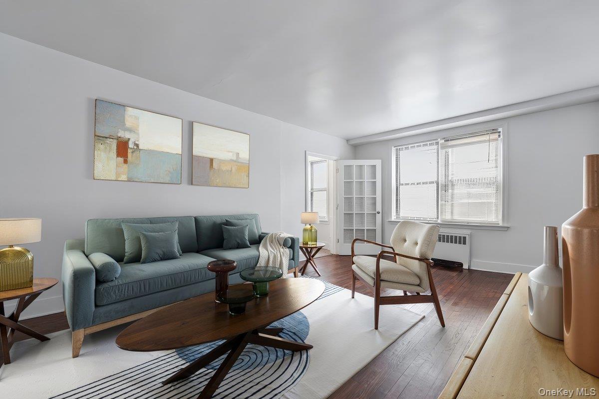 Living room featuring wood finished floors and radiator heating unit