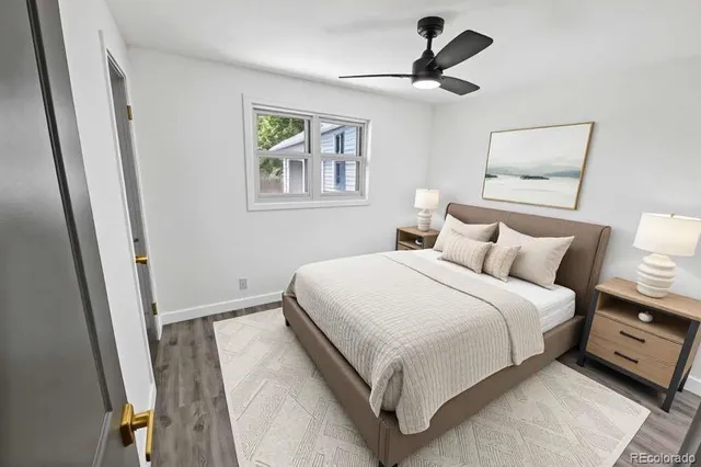 a bedroom with a bed and a painting on the wall