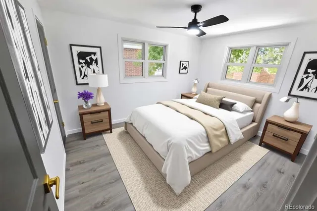 a bedroom with bed and a large window