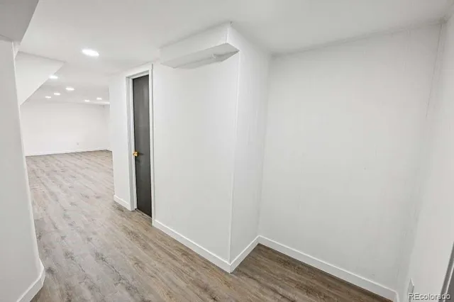 a view of hallway with wooden floor