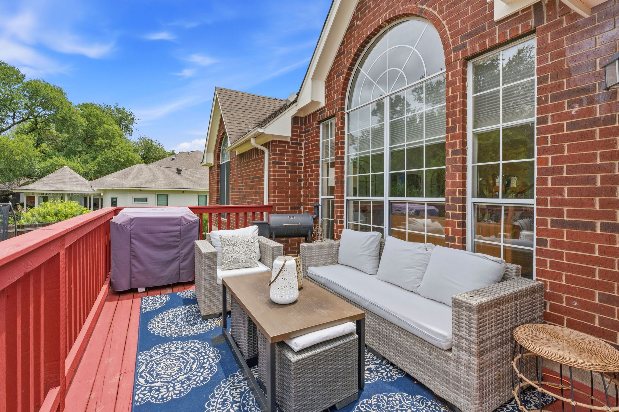 8317 Pommel Drive Austin, TX 78759 - Photo 22 of 26 An inviting deck extends from a brick home, providing an ideal setting for outdoor gatherings.
