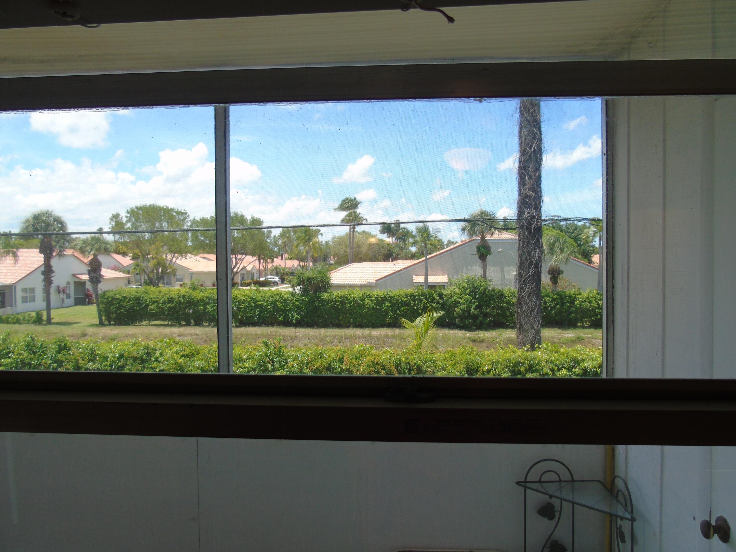219 Normandy Lane Delray Beach, FL 33484 - Photo 14 of 33 a view of a back yard from a window