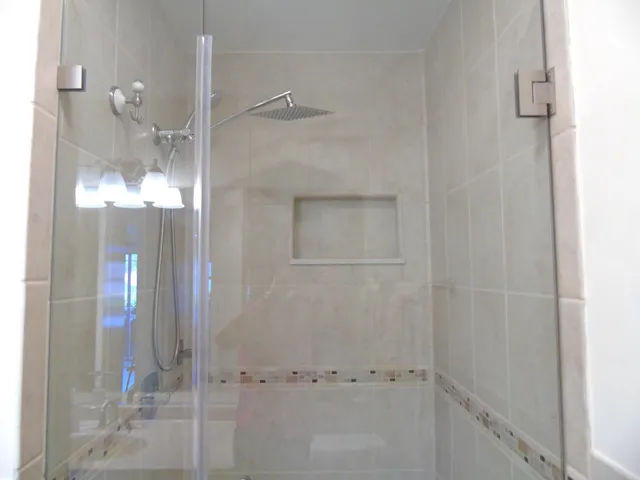 a bathroom with a glass shower door