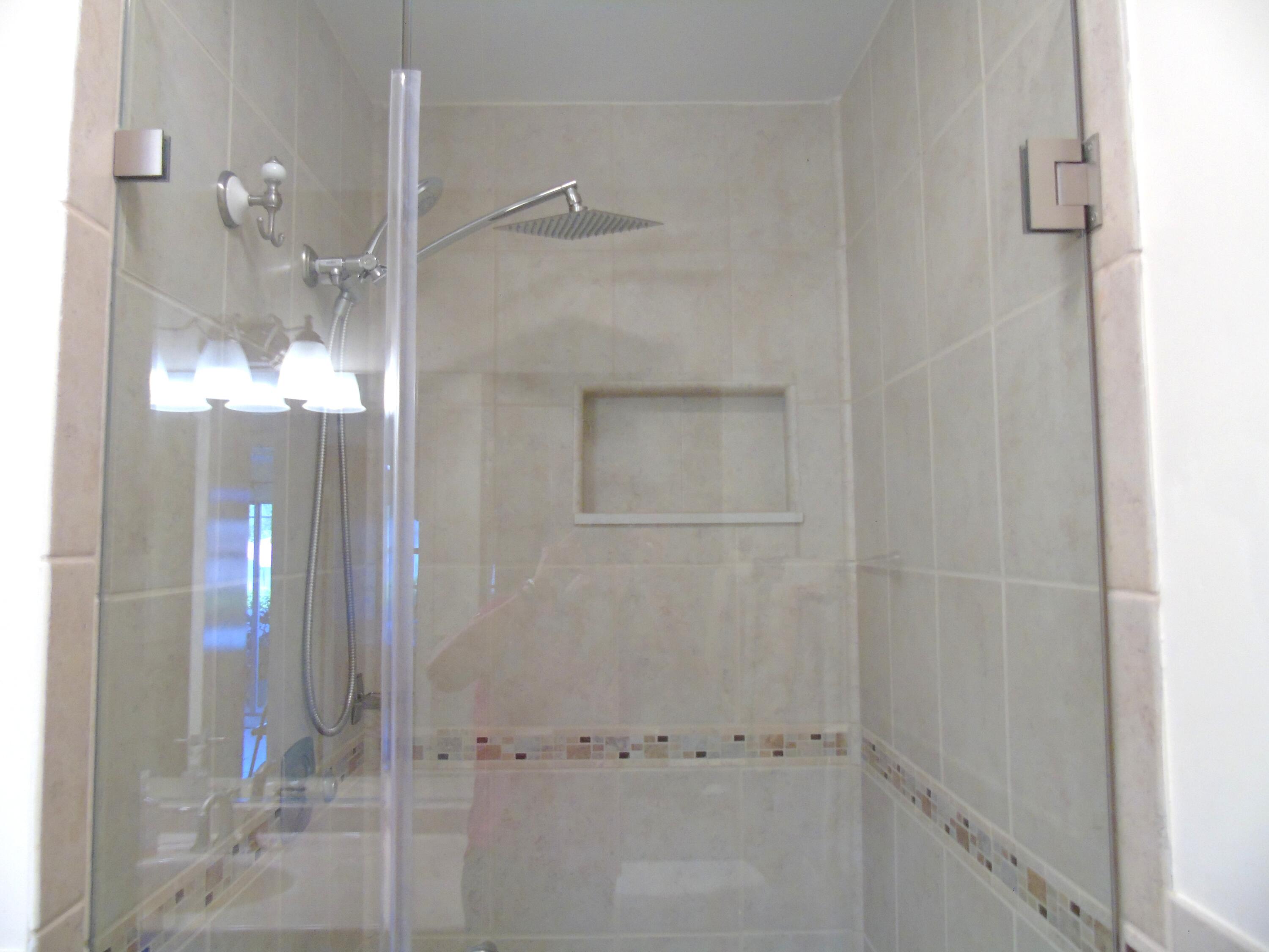 219 Normandy Lane Delray Beach, FL 33484 - Photo 16 of 33 a bathroom with a glass shower door