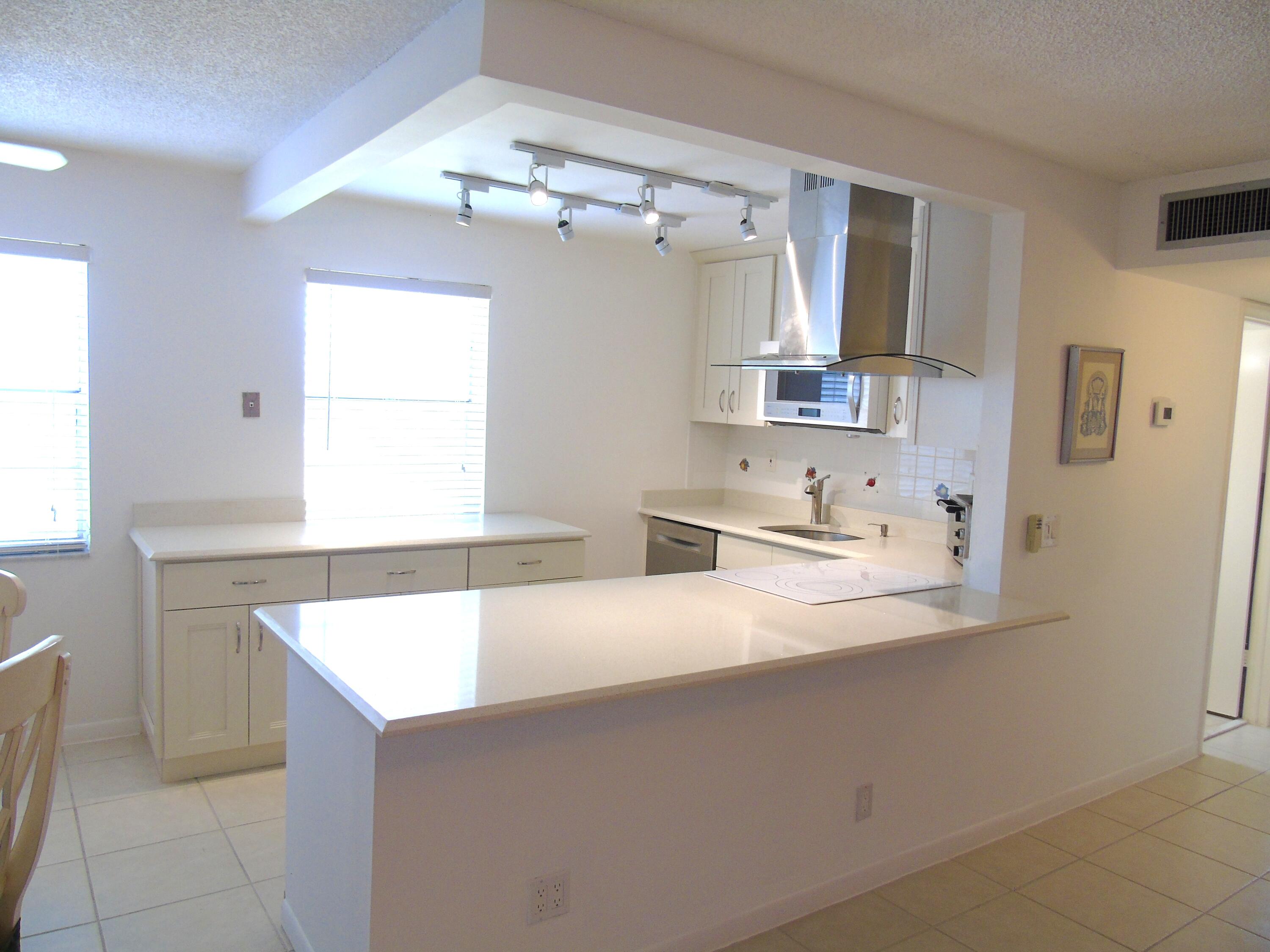 219 Normandy Lane Delray Beach, FL 33484 - Photo 3 of 33 a bathroom with a sink vanity and mirror