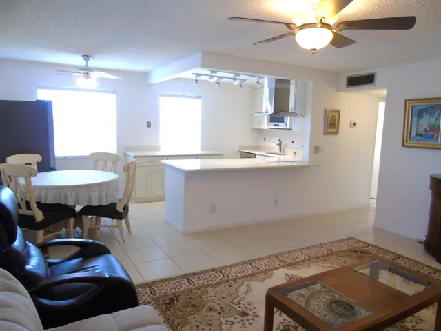 a kitchen with a table chairs and a chandelier