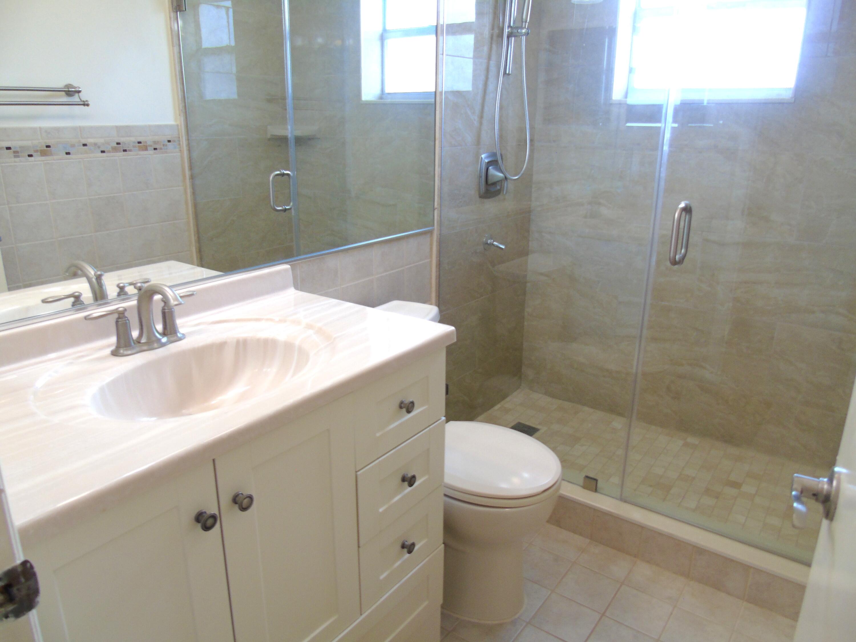 219 Normandy Lane Delray Beach, FL 33484 - Photo 9 of 33 a bathroom with a sink toilet and shower