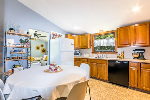 a dining room with furniture and a floor to ceiling window