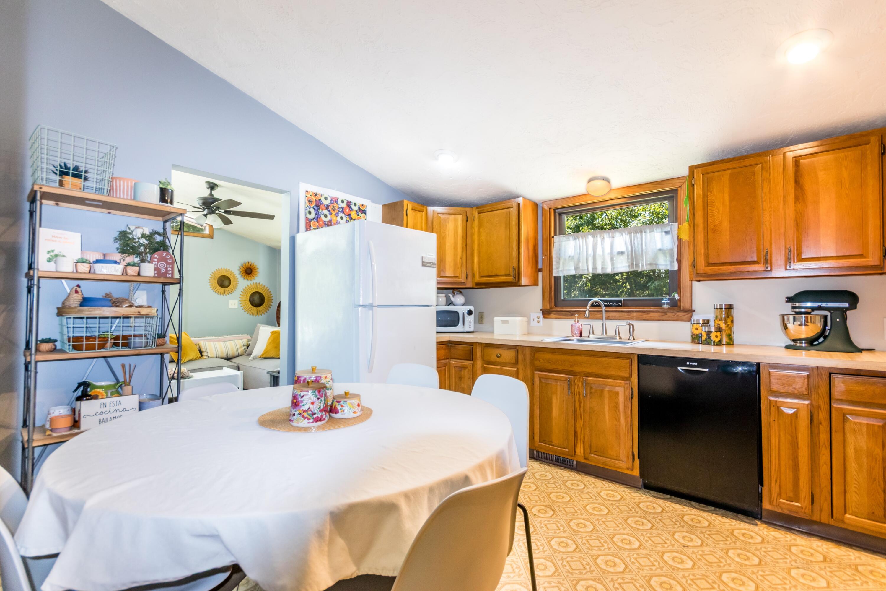 32 North Carver Road West Wareham, MA 02576 - Photo 12 of 42 a kitchen with stainless steel appliances granite countertop a refrigerator a sink dishwasher a dining table and chairs with wooden floor