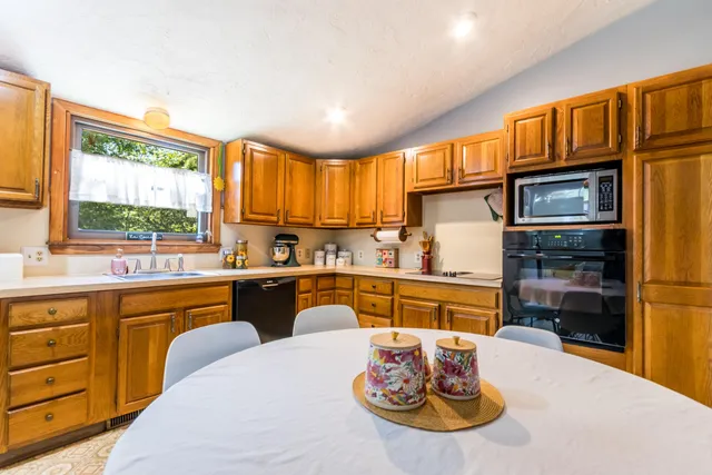 a kitchen with a sink stove and cabinets