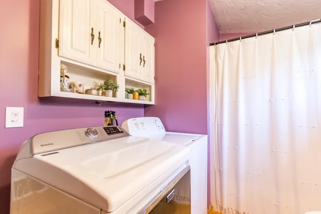 a bathroom with a sink a toilet and a window