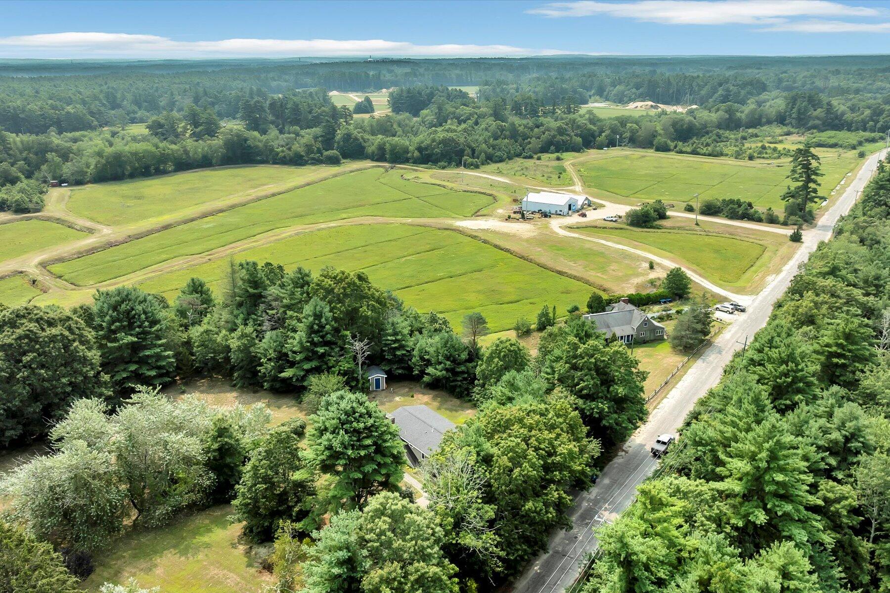 32 North Carver Road West Wareham, MA 02576 - Photo 3 of 42 an aerial view of a house with a yard and lake view