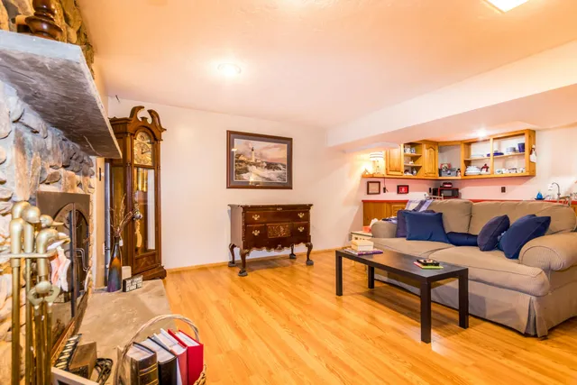 a living room with furniture a fireplace and a flat screen tv