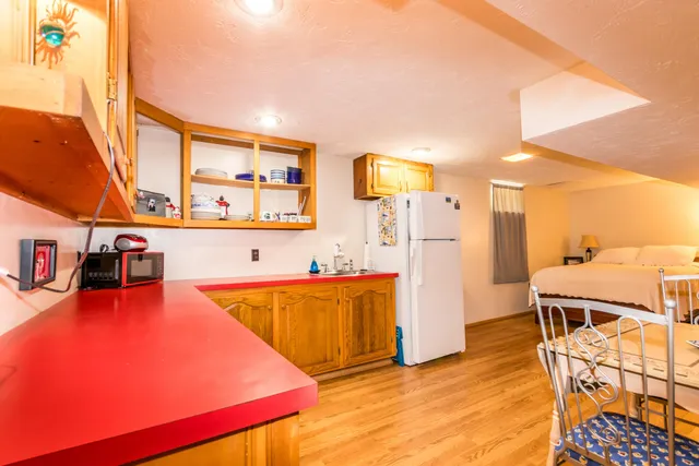 a kitchen with stainless steel appliances granite countertop a refrigerator and a stove top oven