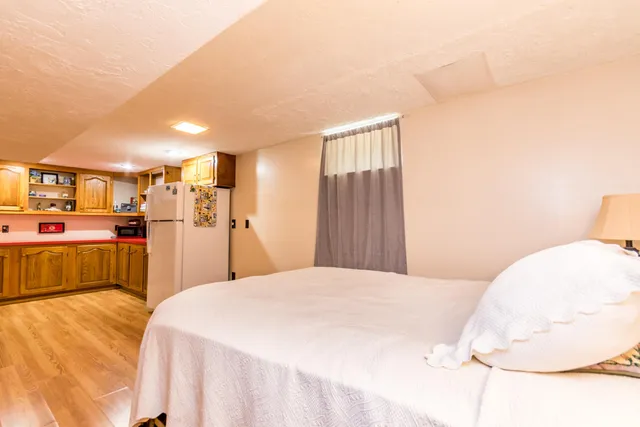 a large kitchen with stainless steel appliances kitchen island granite countertop a refrigerator and a stove top oven